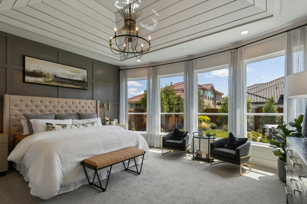 modern bedroom with chandelier and layered lighting