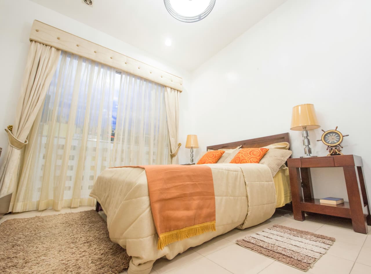 bedroom with only overhead ceiling lighting at night