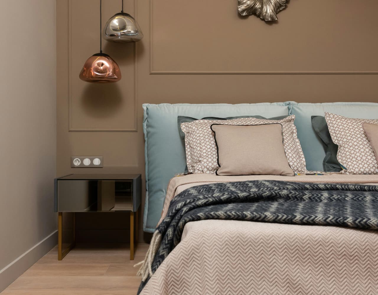 small glass pendant light beside bedroom bed