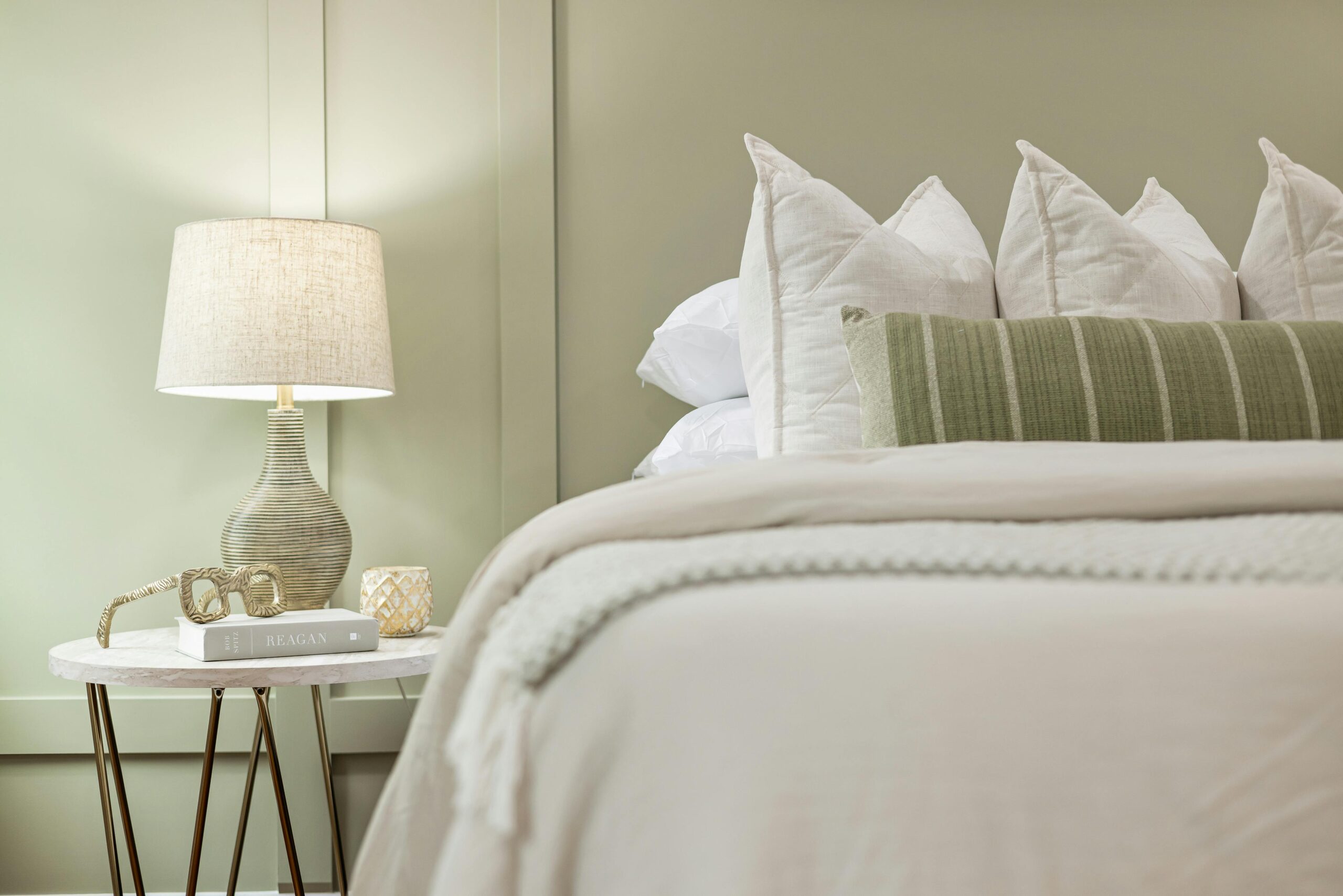 soft warm bedside lamp with fabric shade in a neutral bedroom